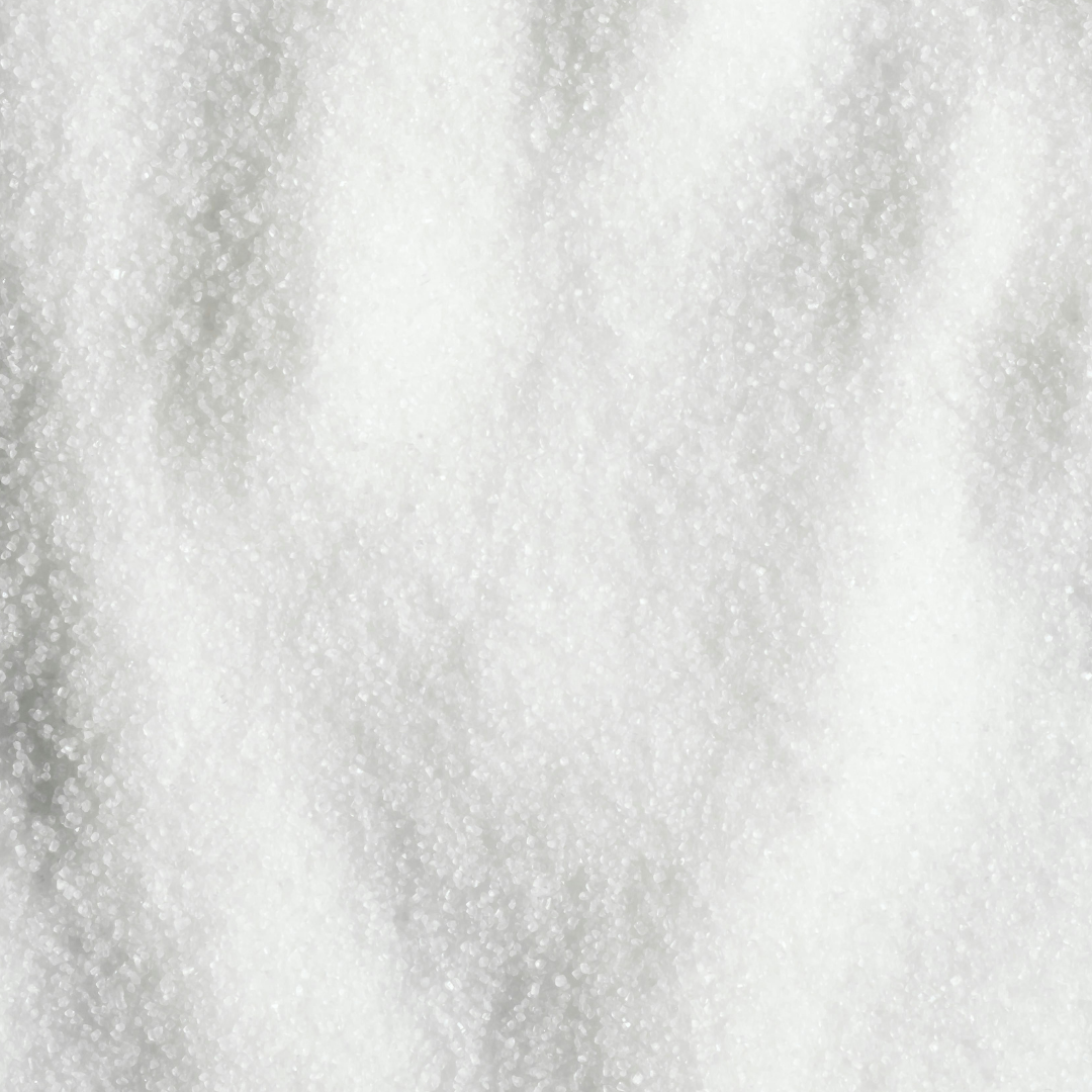 Close-up of allulose granules showing sugar-like texture in a natural sweetener format